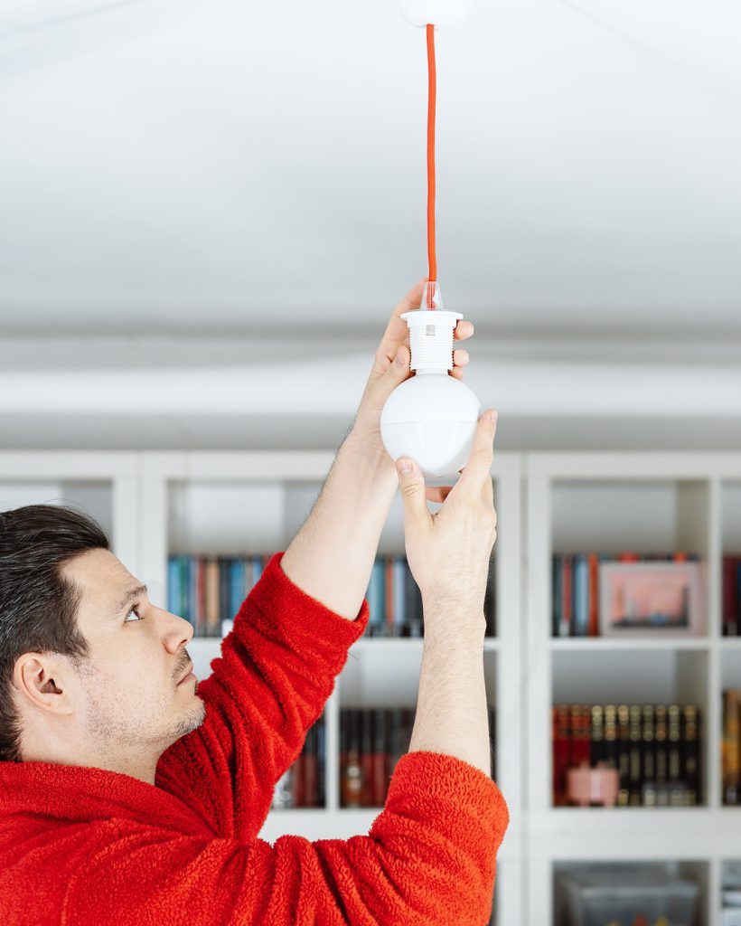 electrician installing light fixture